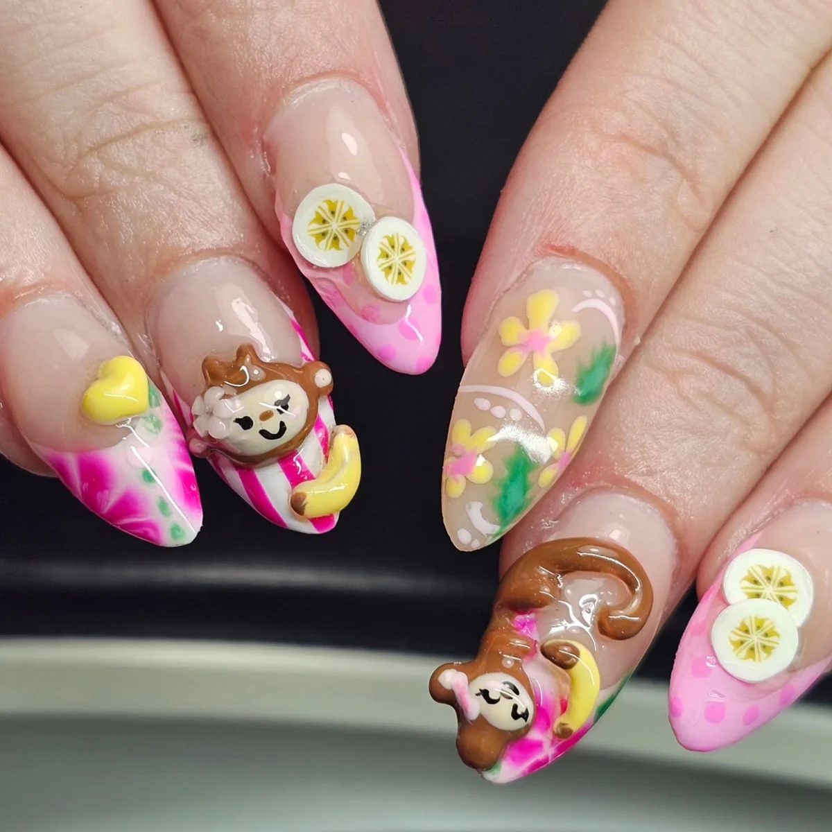 Pink and green nails with flowers, citrus slices and raised character accents