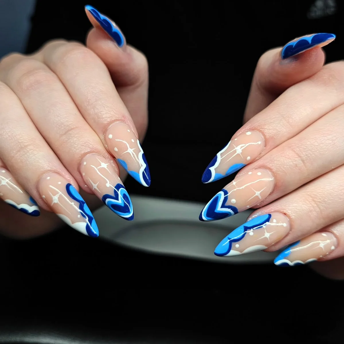 Long nude nails with vivid blue flame tips