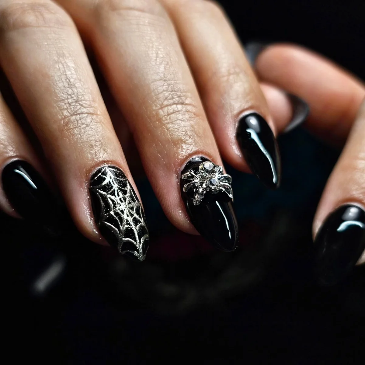 Long black nails with white spiderweb and silver accents