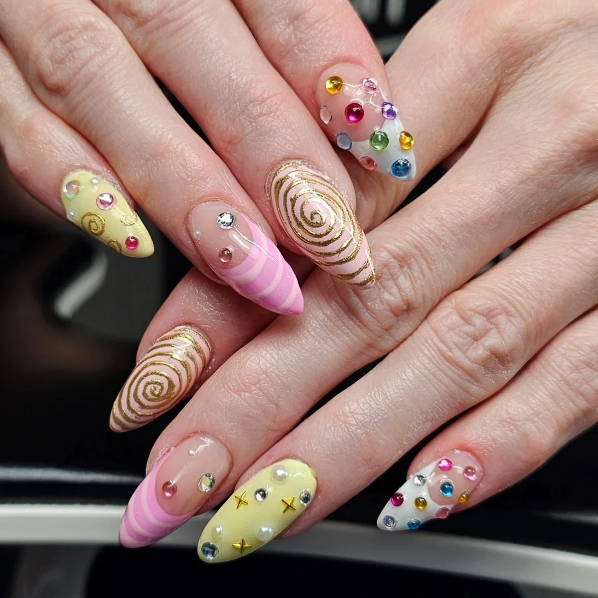 Pastel nails with raised swirls and colourful dot accents