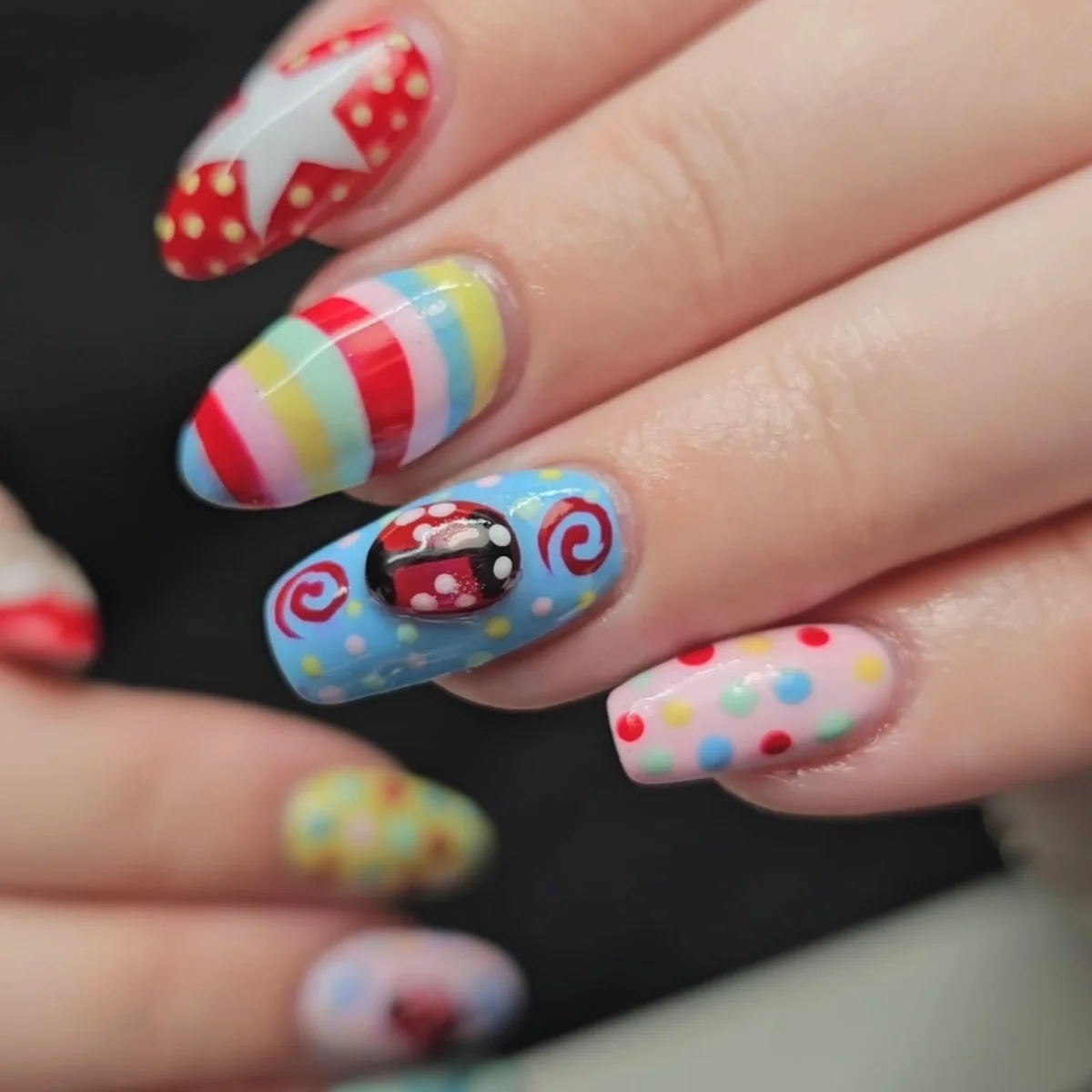 Colourful nails with rainbow stripes, dots and graphic accents