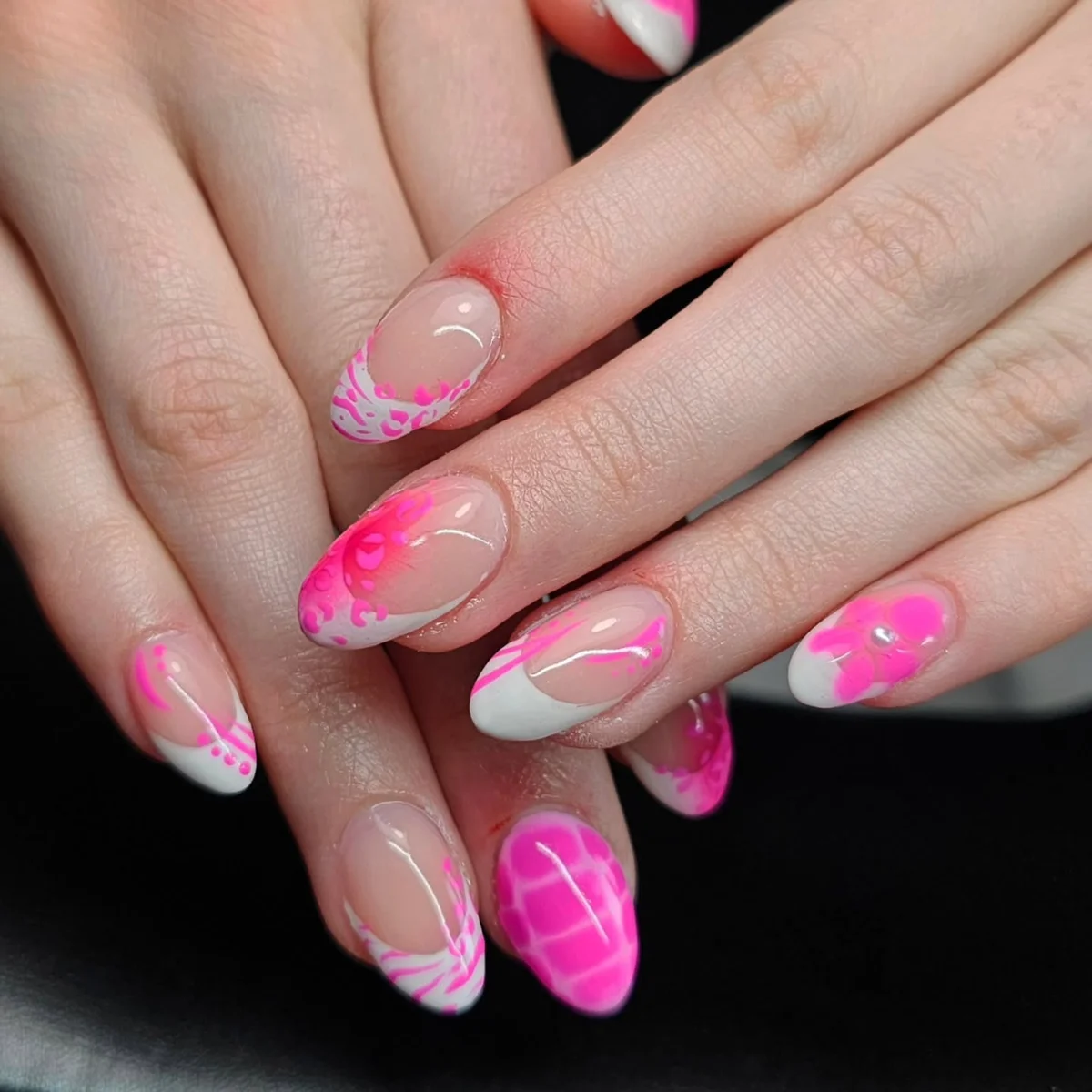 Nude nails with bright pink swirls and floral accents