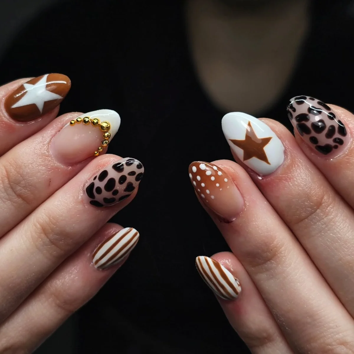 Brown and cream nails with leopard spots, stars and striped accents
