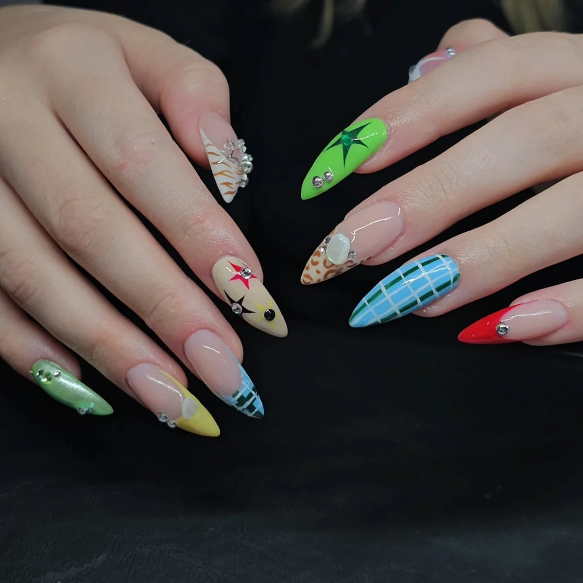 Long nails with mixed green, blue, pink and floral designs