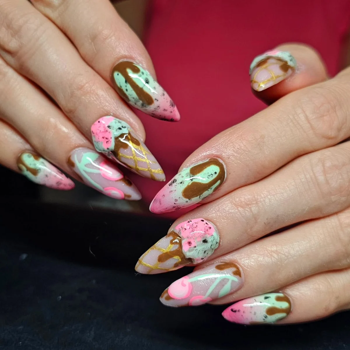 Pastel nails with raised flowers, green swirls and pink accents