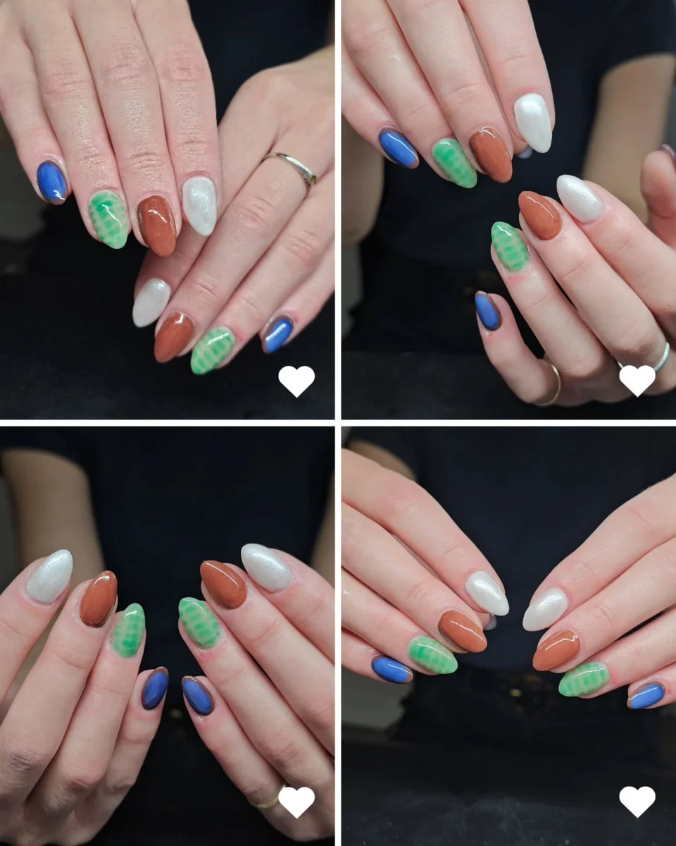 Pastel manicure with individual blue, green, lilac and white tips