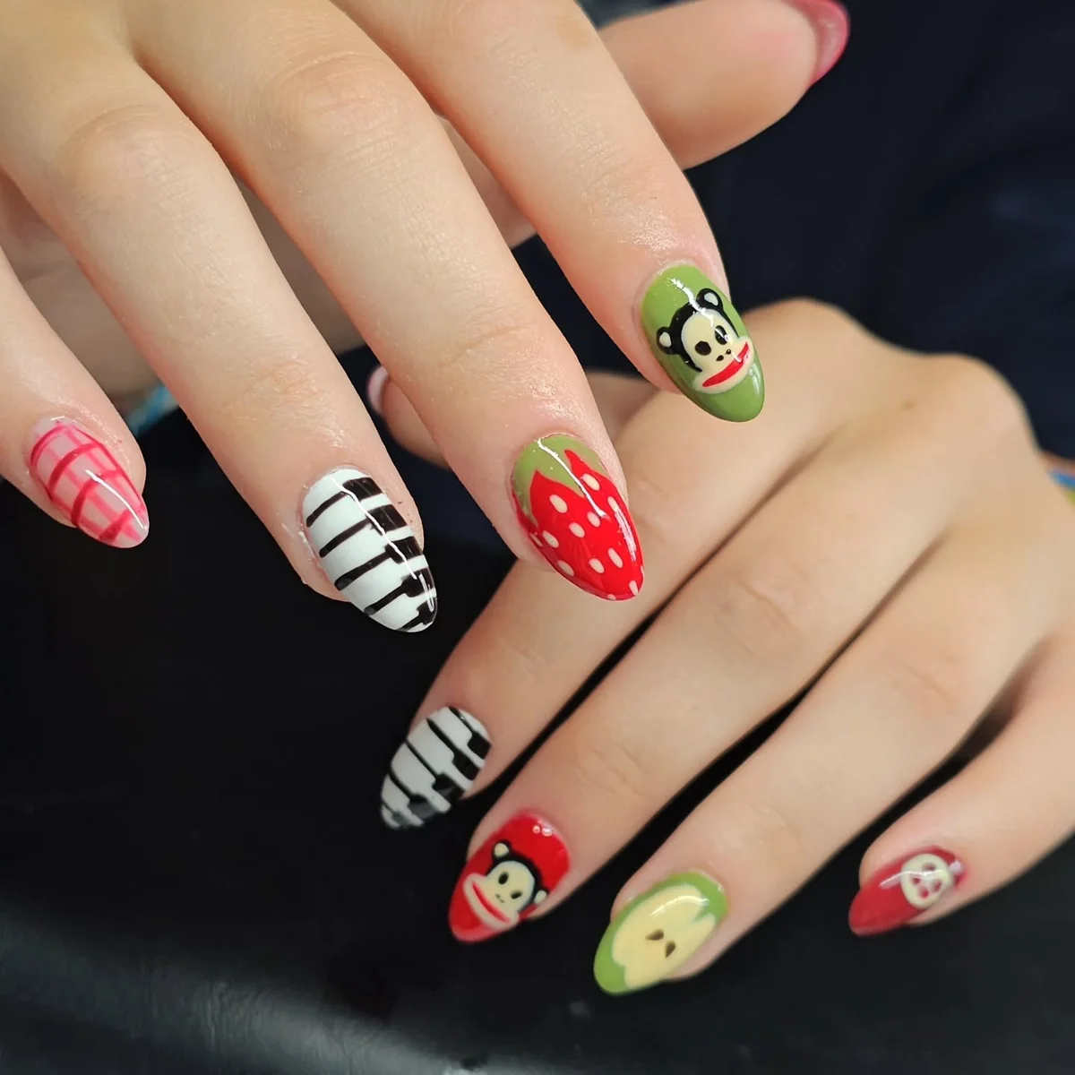 Colourful nails with stripes, red dots and character accents