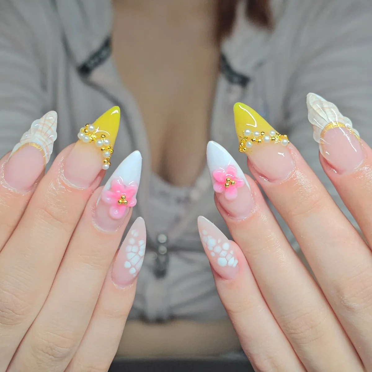 Long pastel nails with yellow tips, flowers and glitter