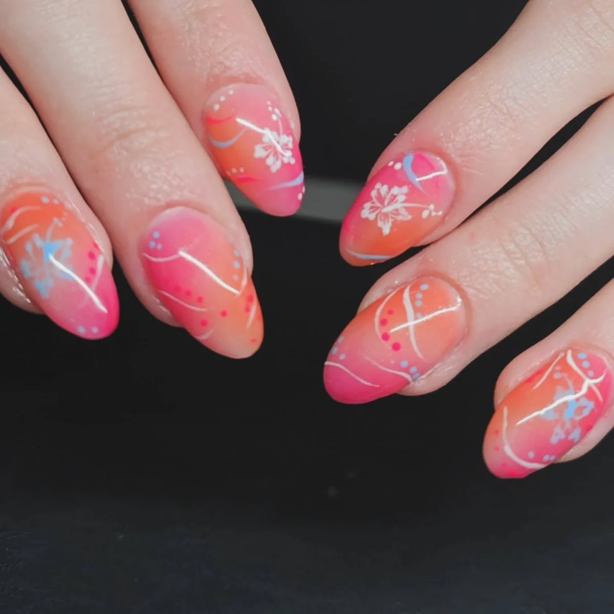 Coral and pink nails with white flower and line details