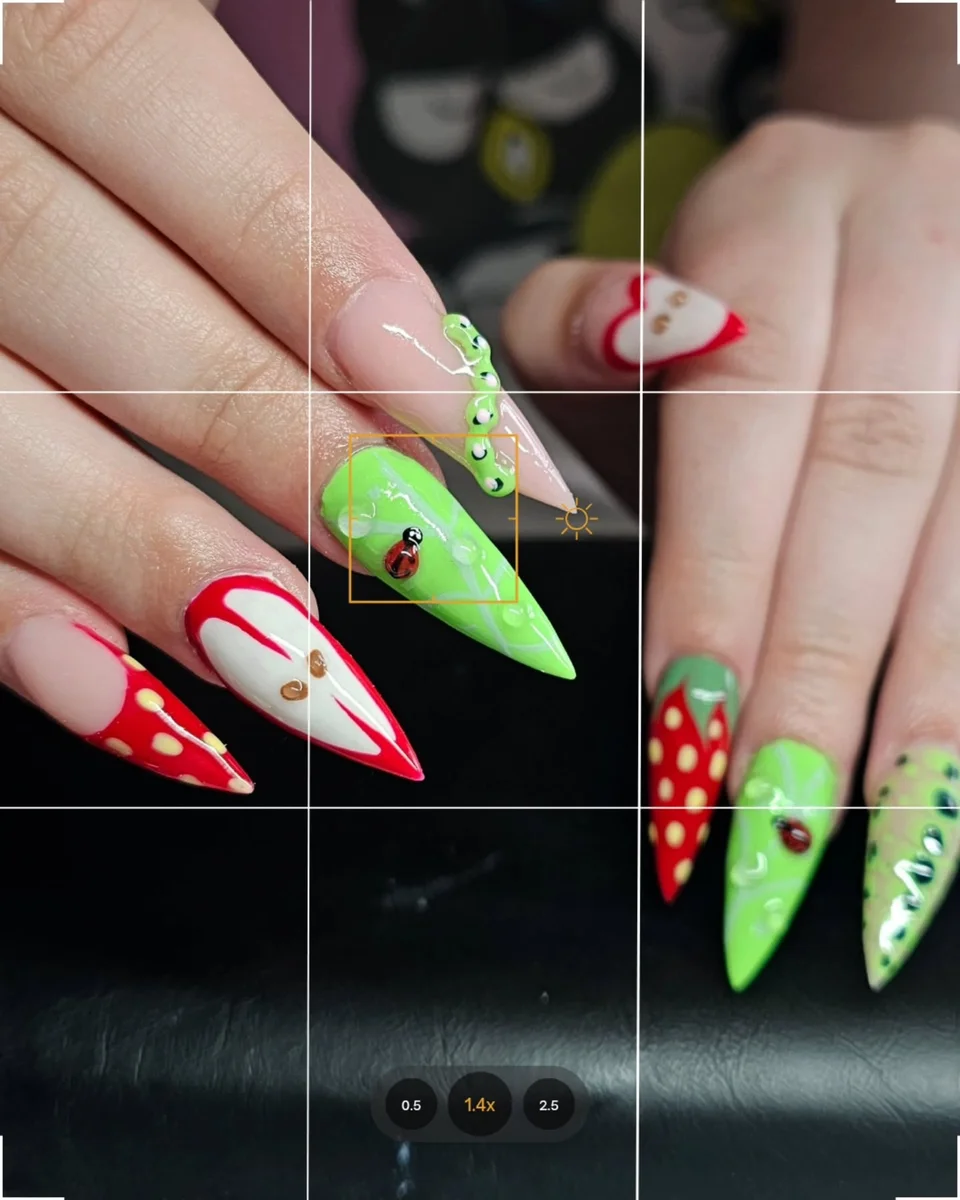 Long red and bright green nails with white and floral details