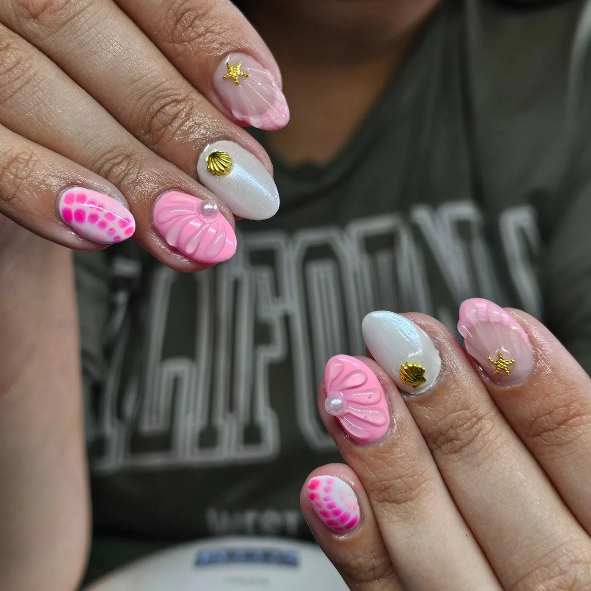 Pink textured nails with small floral accents
