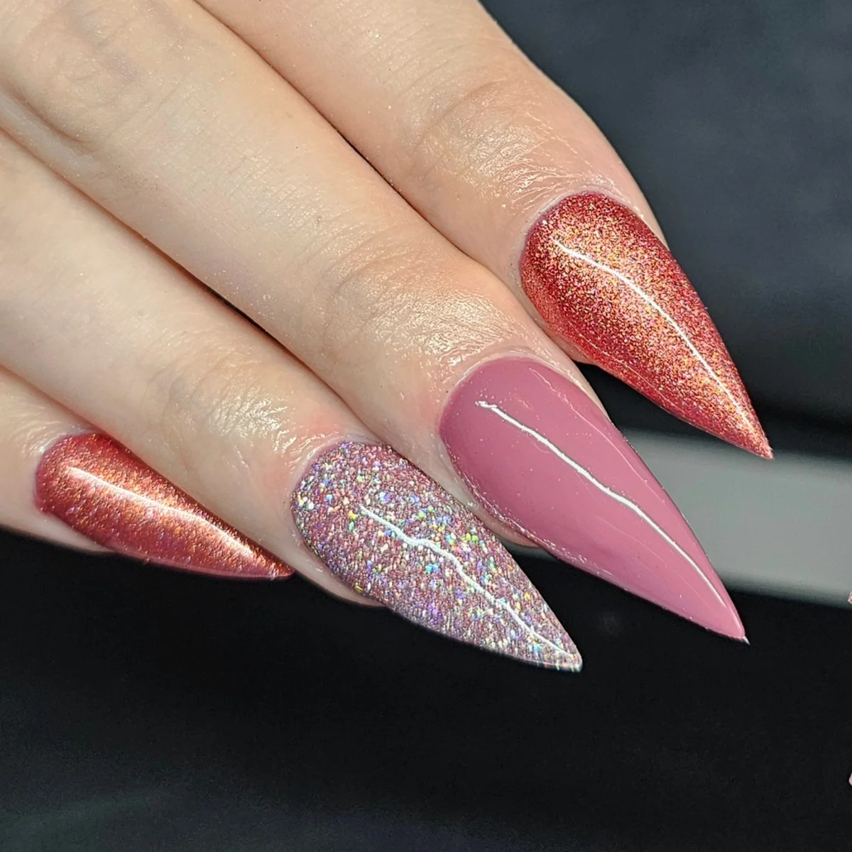 Long pointed nails in rose, copper shimmer and silver glitter