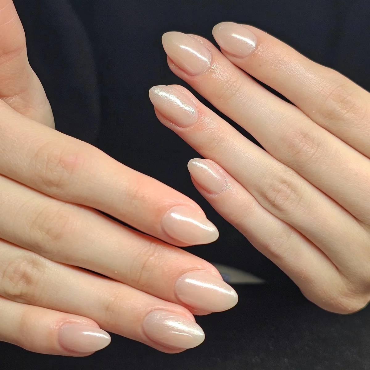 Glossy nude almond nails with delicate white tips