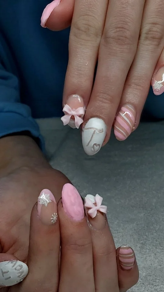 Pink and pale nails with raised flowers, curved stripes and fine white details.